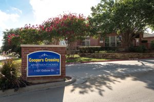 Cooper's Crossing Apartment Homes sign, 1101 Oxbow Dr, drive entrance